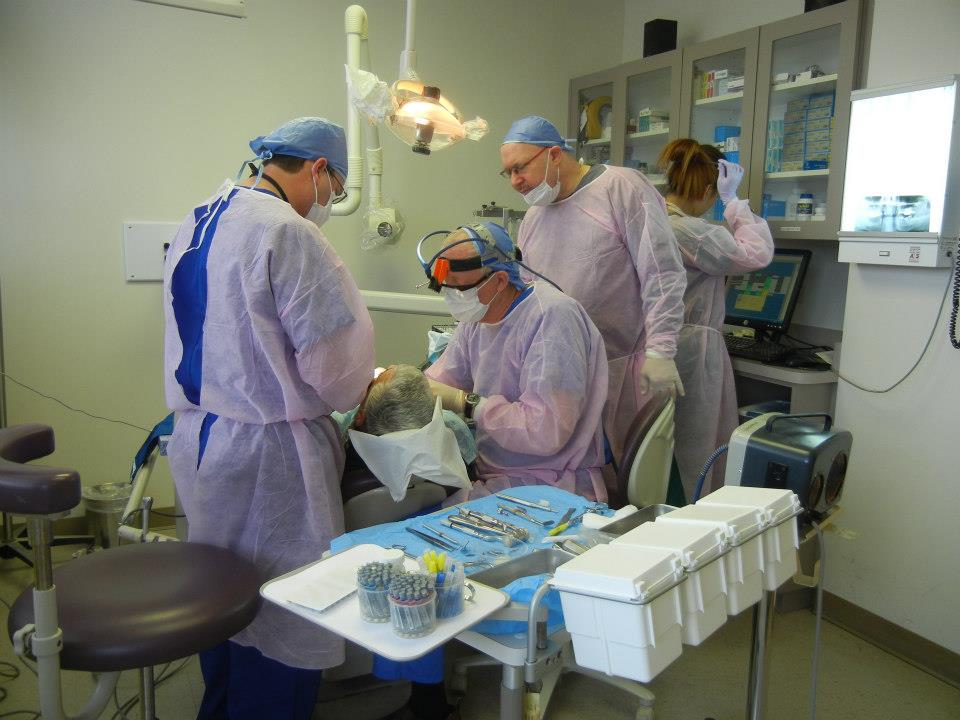 Dentists performing live implant surgery during a hands-on three-day training course in New Jersey.