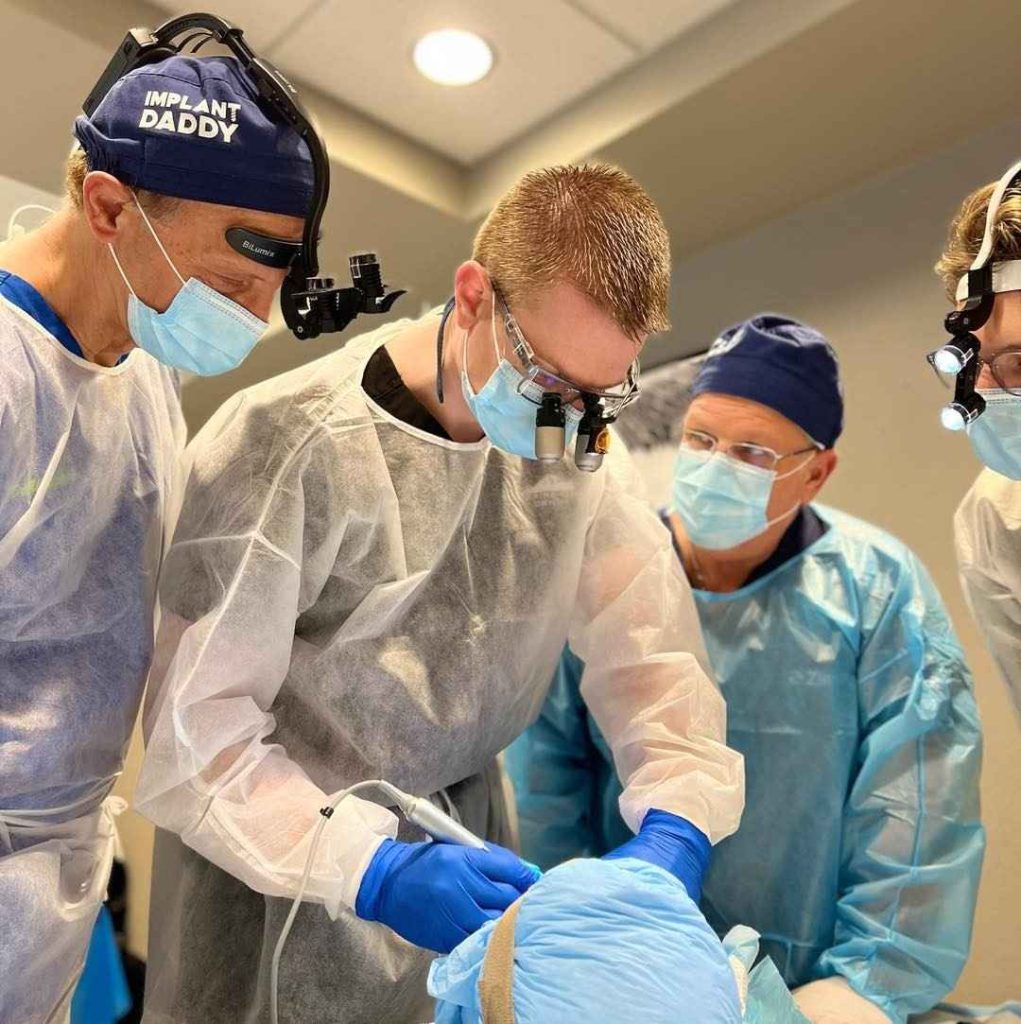Dentists performing hands-on implant training during the Maxicourse program.