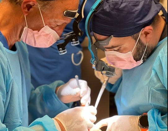Dentists performing dental implant surgery during hands-on Maxicourse training program. What Is the Value of Maxicourse Dental Implant Certification?